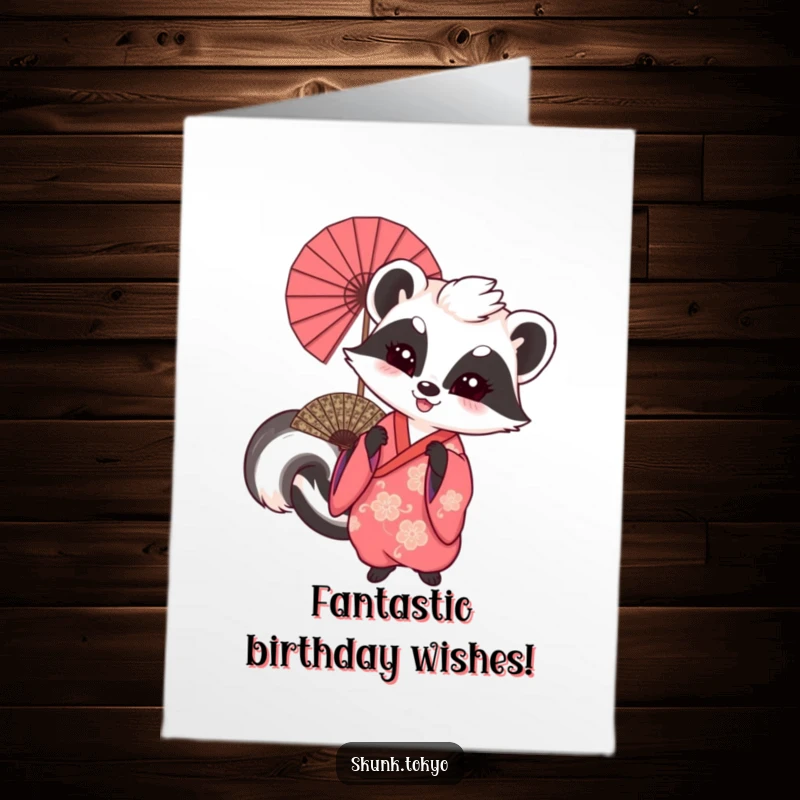 Funny Free Printable Birthday Card: A skunk in a traditional kimono gleefully waving a large, ornate fan with a smile.